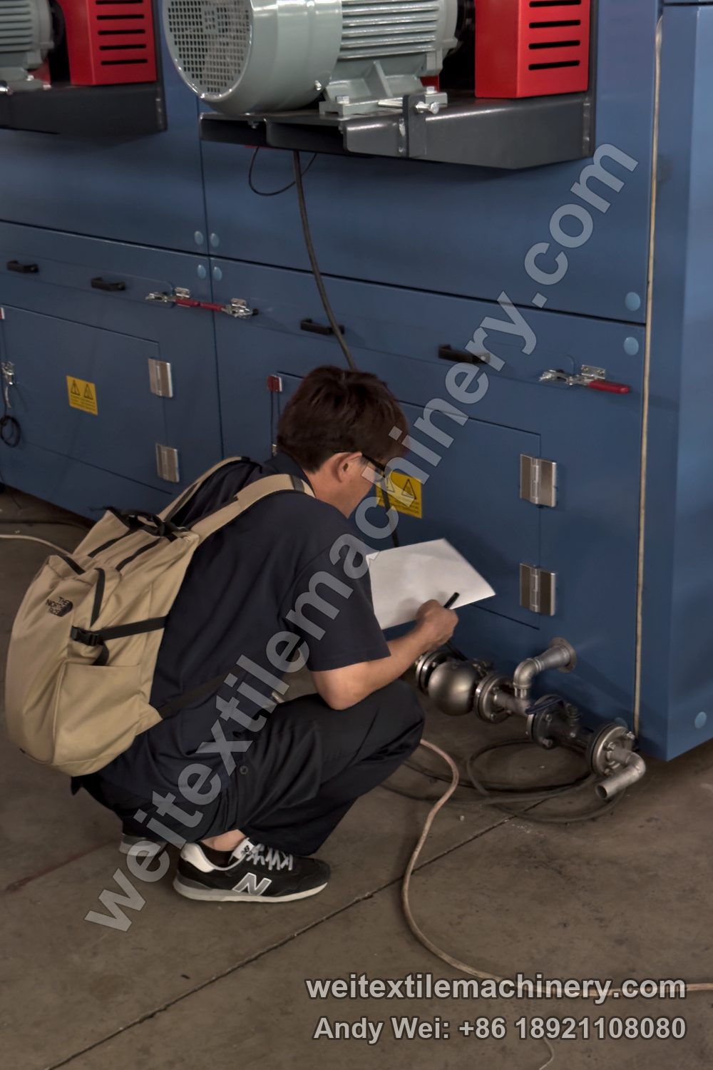 A Miyuki engineer crouching beside the line, taking notes