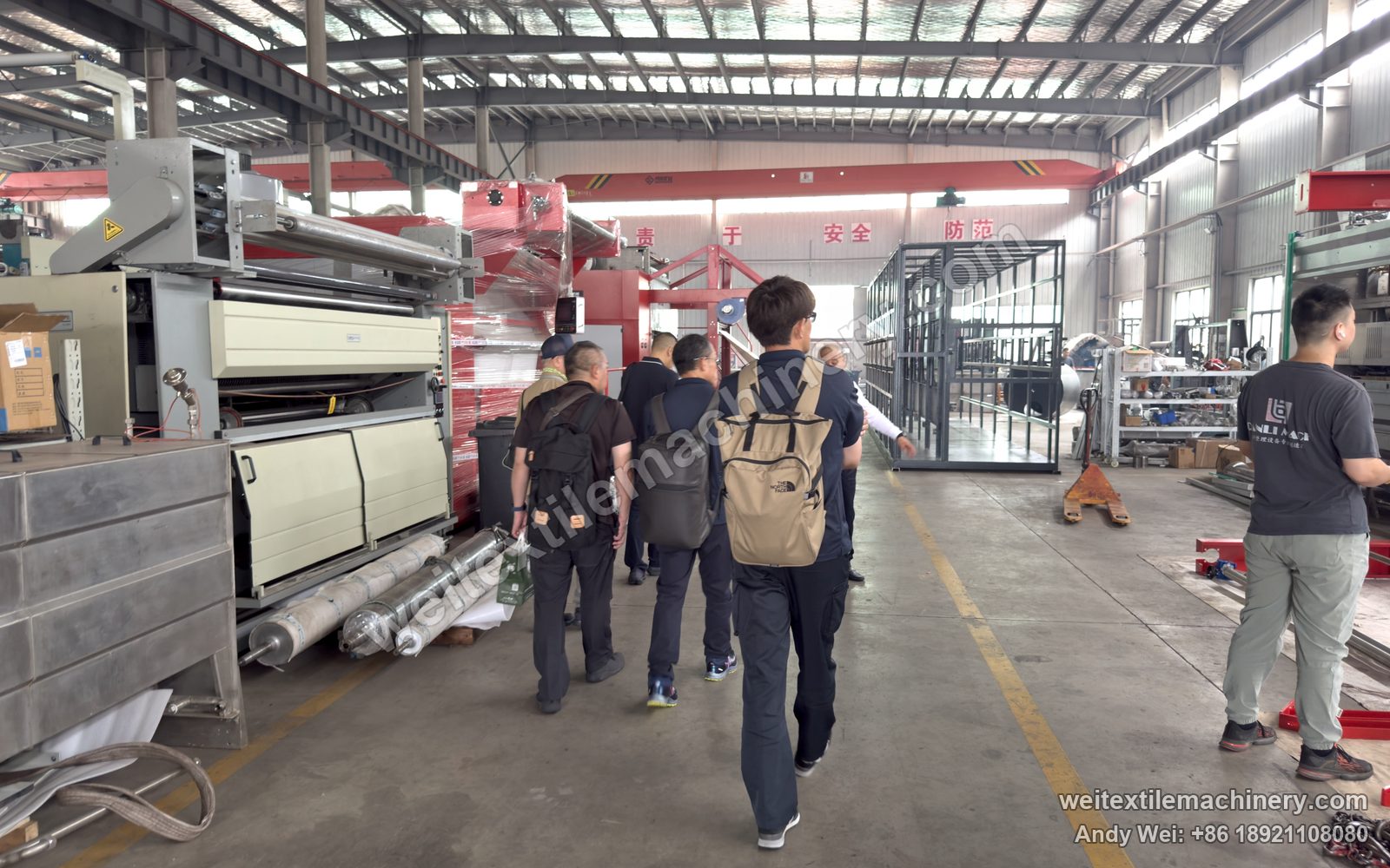 The Miyuki team walking through our plant towards the four-channel scouring and milling machine