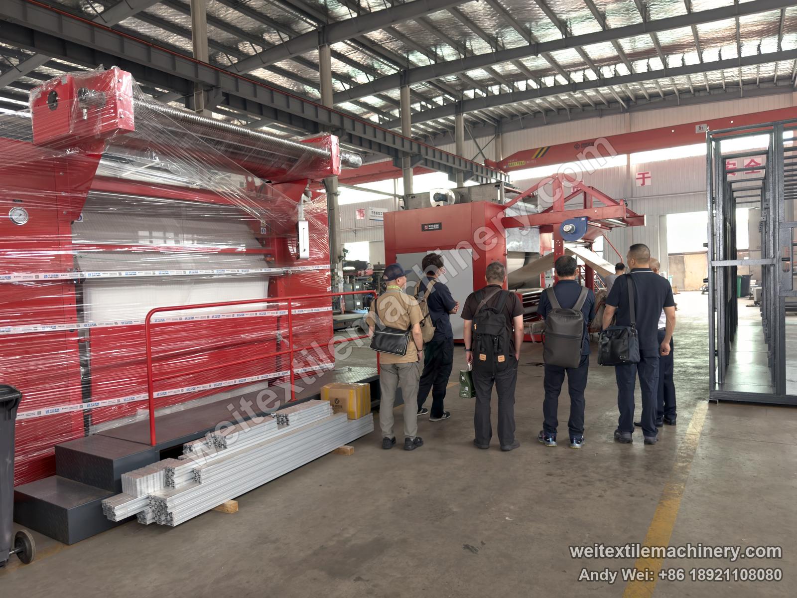 The Miyuki team in front of a QL continuous decatizing machine