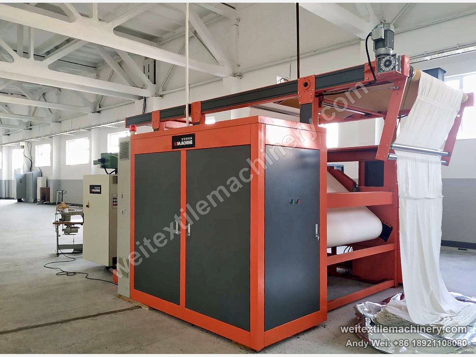 M-Tec Contipress 400 calender in orange and grey, white cloth running over the top frame