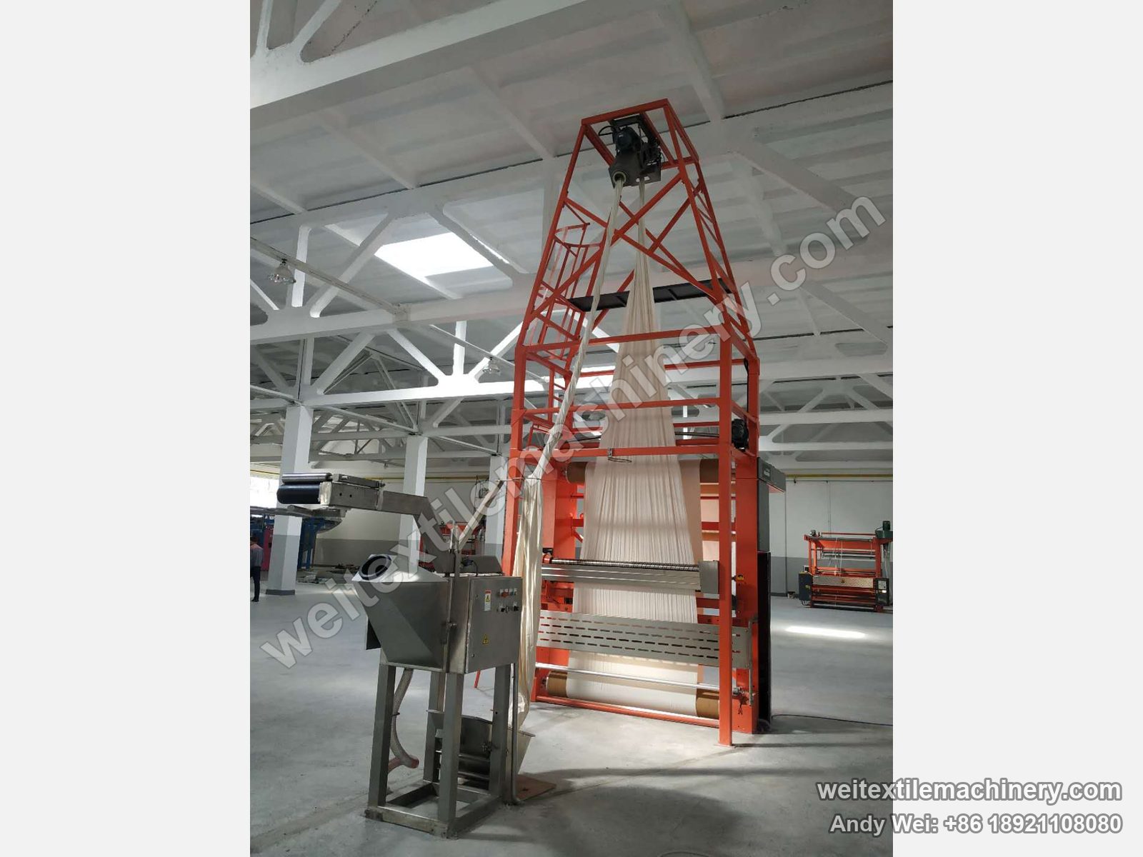 Used Bianco untwisting and opening machine in operation, rope fabric detwisted through the tower and opened out, orange frame and rope feed unit