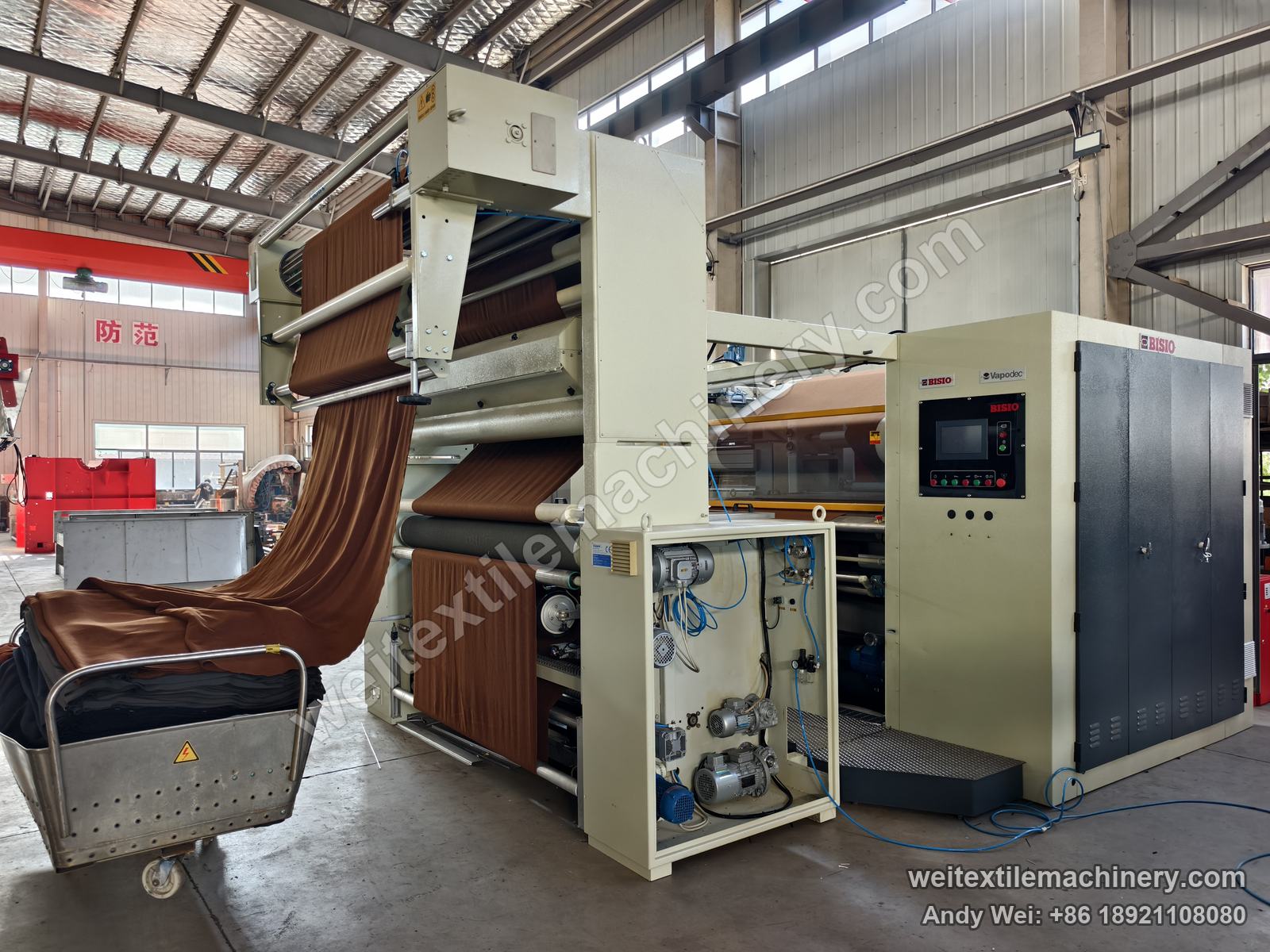 Used Bisio Vapodec continuous decatizing machine, full view from the entry side with fabric fed from a trolley, BISIO and Vapodec badges and touch-screen panel