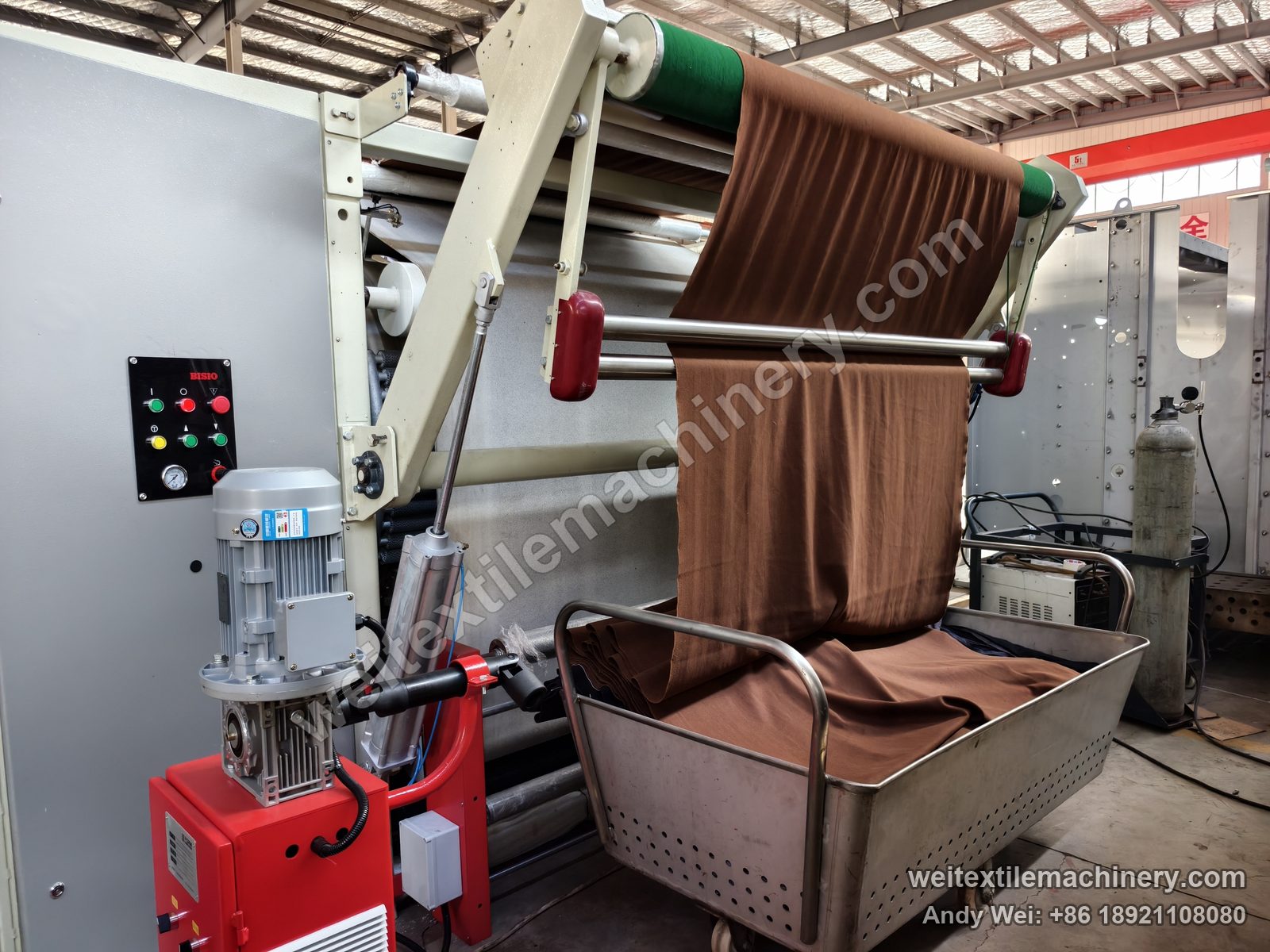 Used Bisio Vapodec continuous decatizing machine delivery end with BISIO button box, geared motor and fabric plaited into the trolley