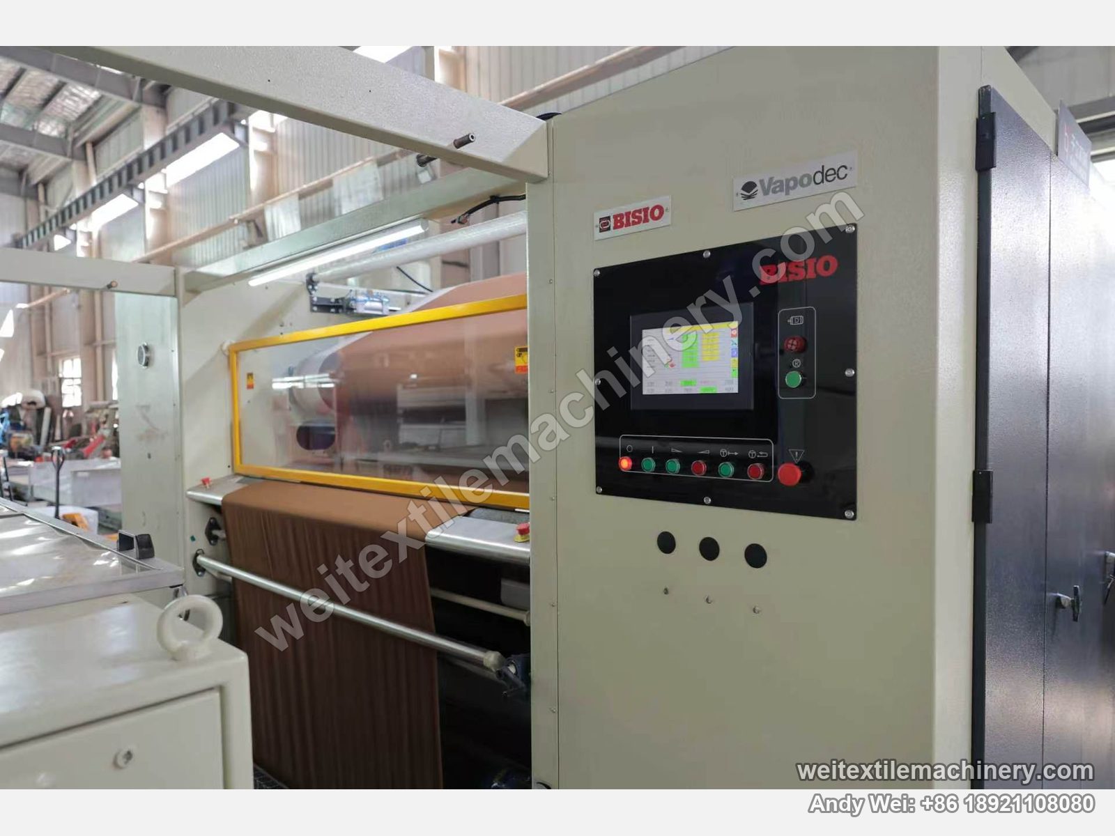 Used Bisio Vapodec continuous decatizing machine control panel with Vapodec and BISIO badges, touch screen and buttons, fabric entering the decatizing zone