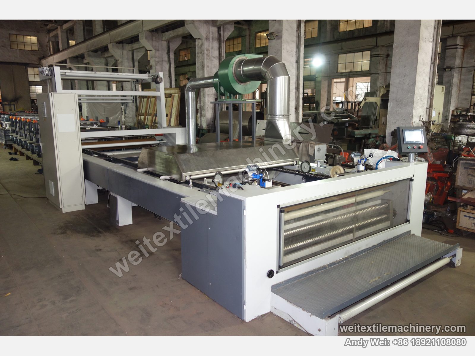 Used CoMaR SIRIO pin-chain steaming-shrinking machine, full view from the delivery end with stainless steam hood and control box