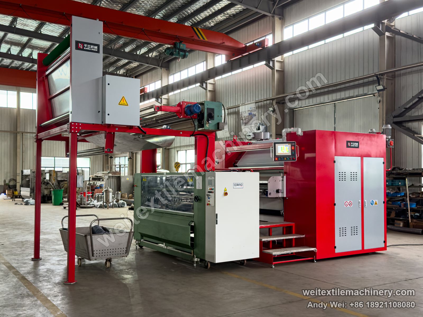 Used Corino pin-wheel weft straightener (newer model) installed in a line at QL's assembly area, green body, Corino plate and clear guard, QL machine behind