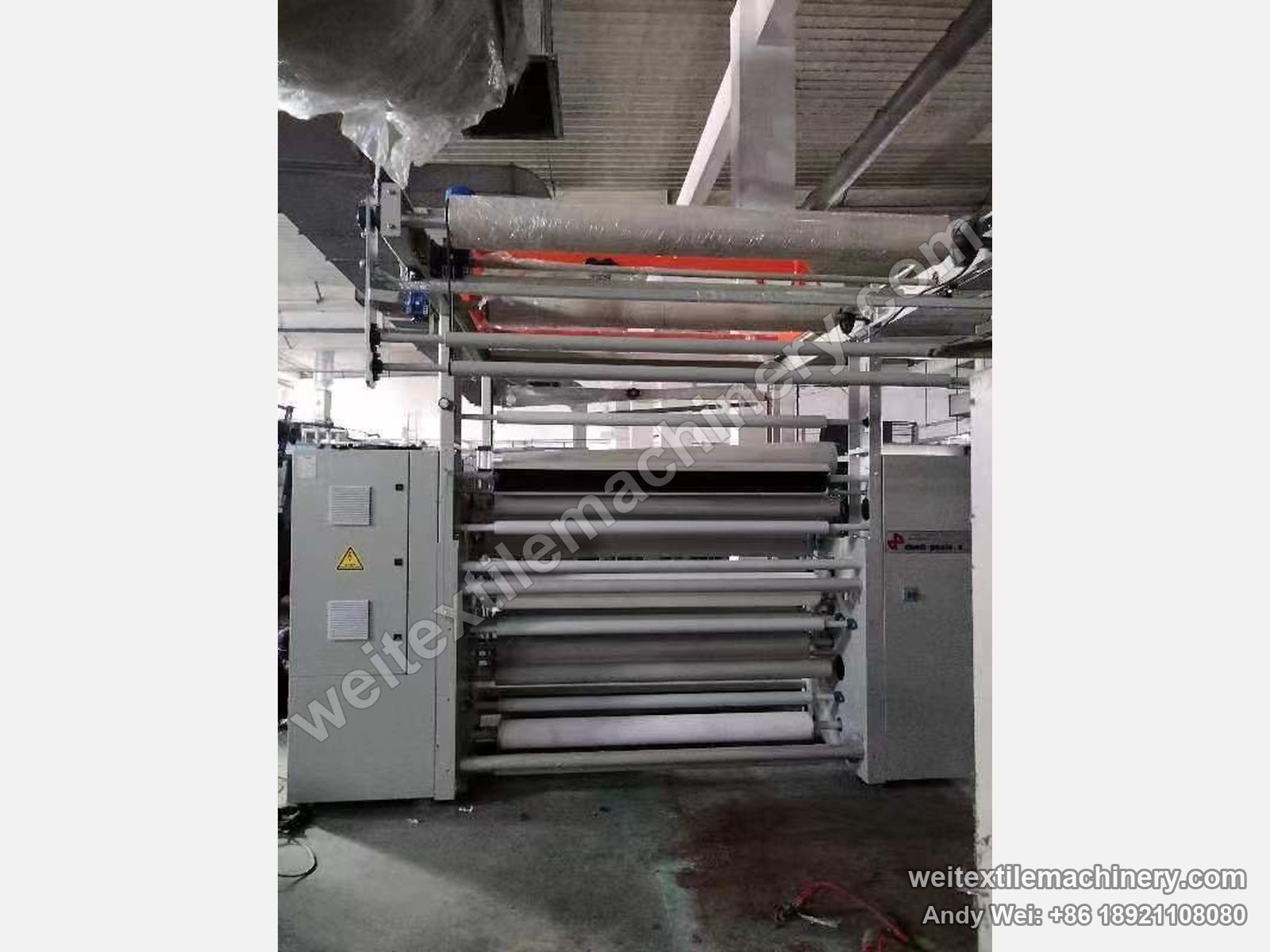 Used Danti Paolo DP7 shearing machine, front close-up with film-wrapped rolls, shearing zone and cabinet
