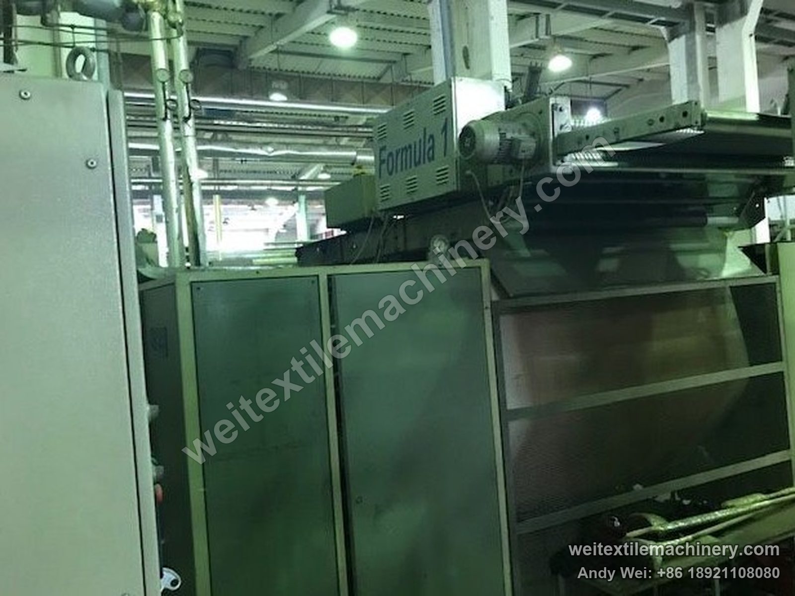 Used KD Formula 1 Formula 1 moistening-calendering-decatizing machine, second unit at three-quarter angle with hood doors, Formula 1 head, fan and mesh guard
