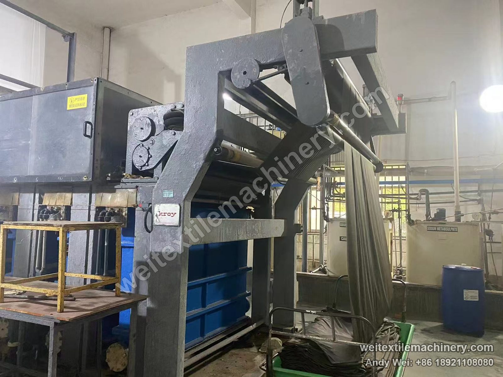 Used Kroy Fabric Machine wool fabric chlorination line, kroy plate on the grey frame, air-bellows nip rolls and fabric over the top guide roll to the trolley