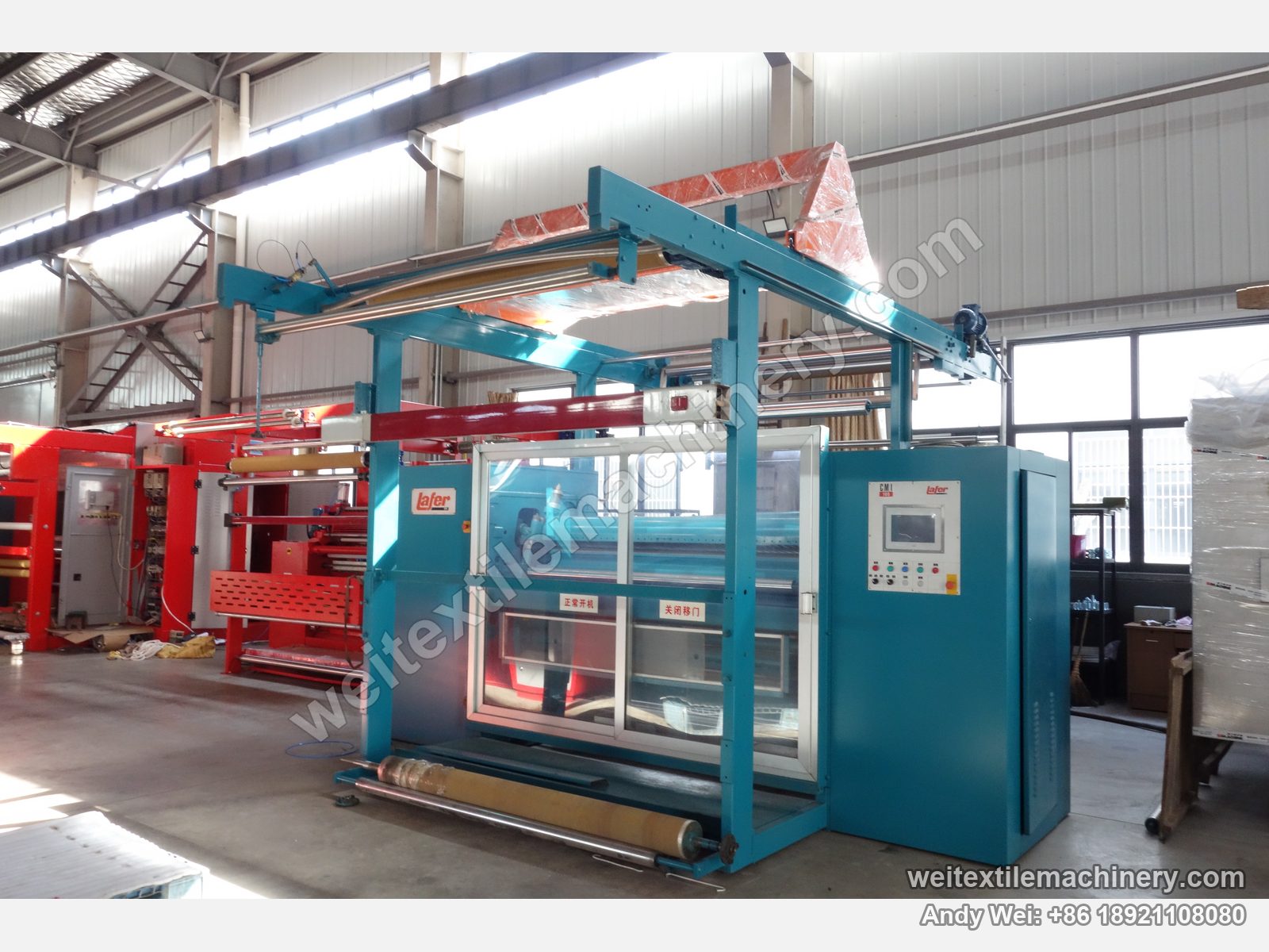 Used Lafer CMI 200 shearing machine after QL rebuild, full view with blue body, overhead fabric frame, clear sliding doors and touch-screen cabinet