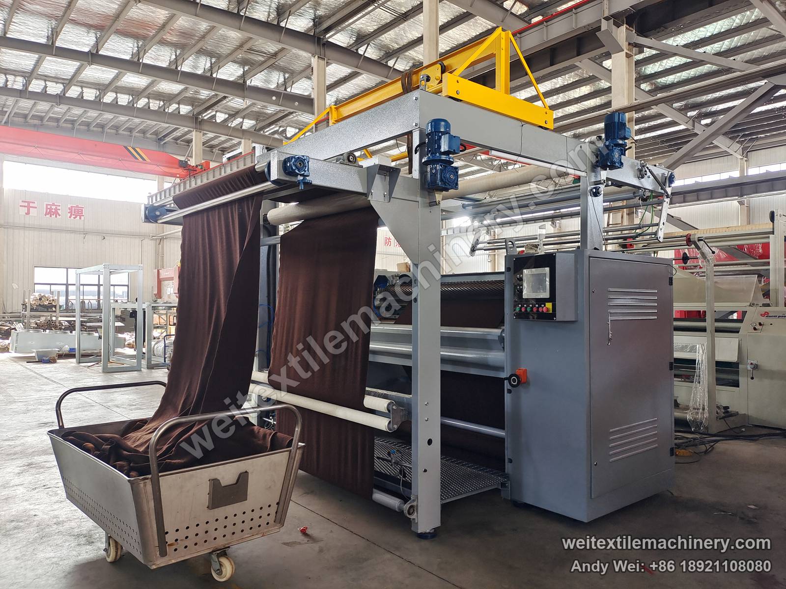 Used M-Tec shearing machine, side view with fabric on the frame, shearing zone and delivery trolley