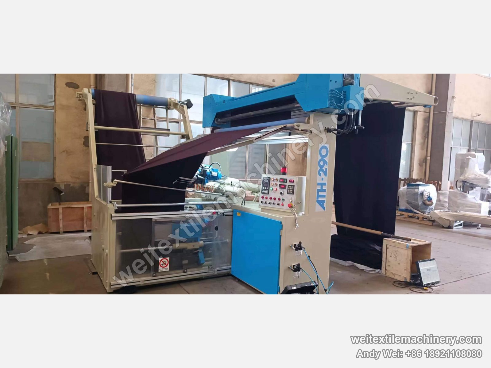 Used Pugi ATH-290 tubular seaming machine, full view with ATH-290 column, overhead fabric frame with dark cloth, sewing head and FLC3 control panel