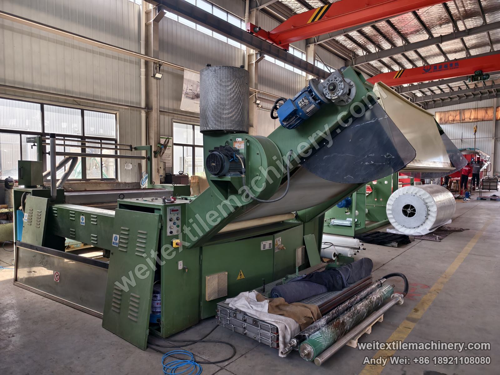 Used Sperotto Rimar belt-type steaming-shrinking machine, drive end with blower, cylindrical filter drum, blue geared motor and a roll of white mesh belt