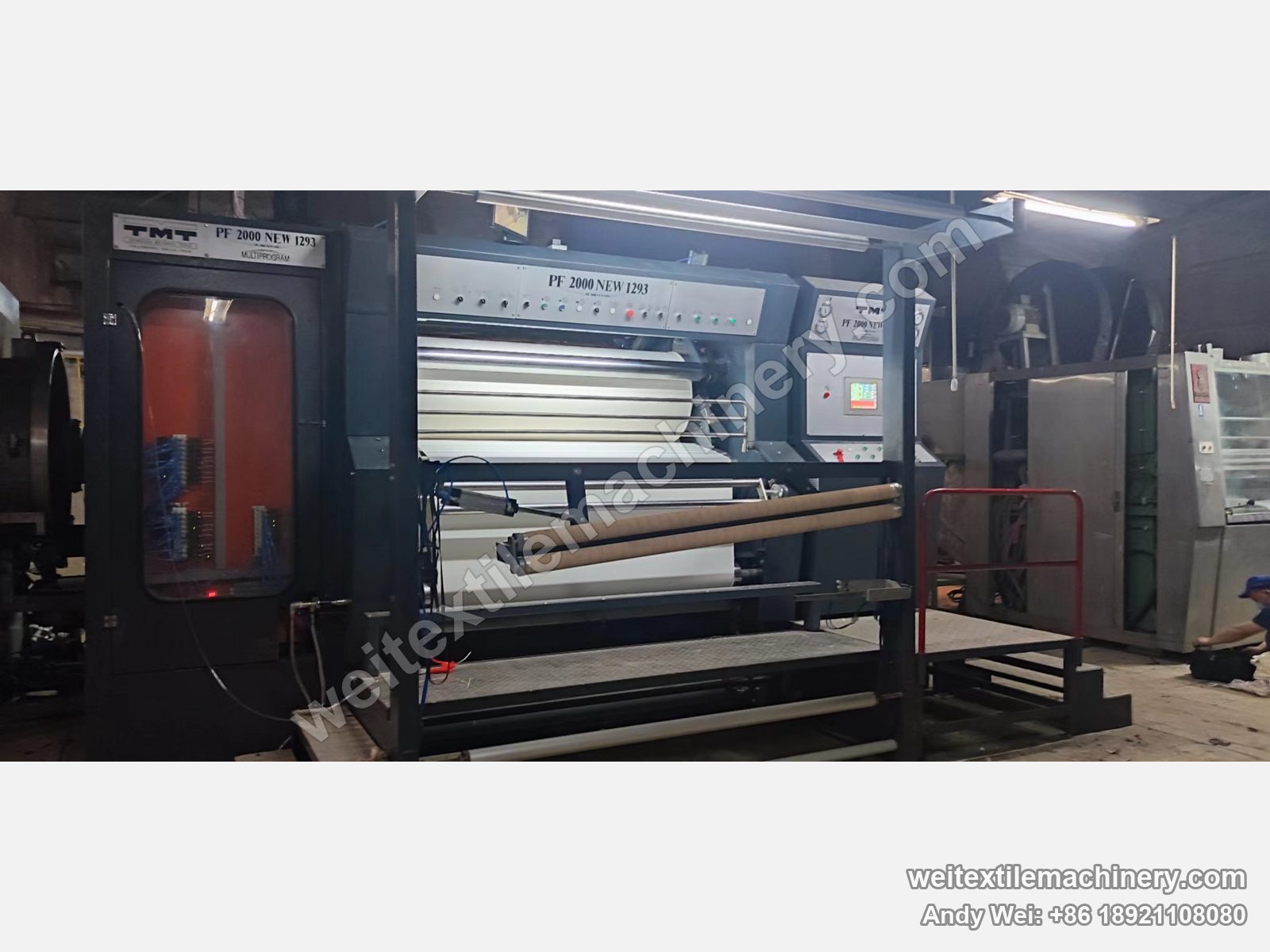 Used TMT PF 2000 NEW 1293 kier decatizing machine with PF 2000 NEW 1293 marking, fabric on the batching roll and red guard rail