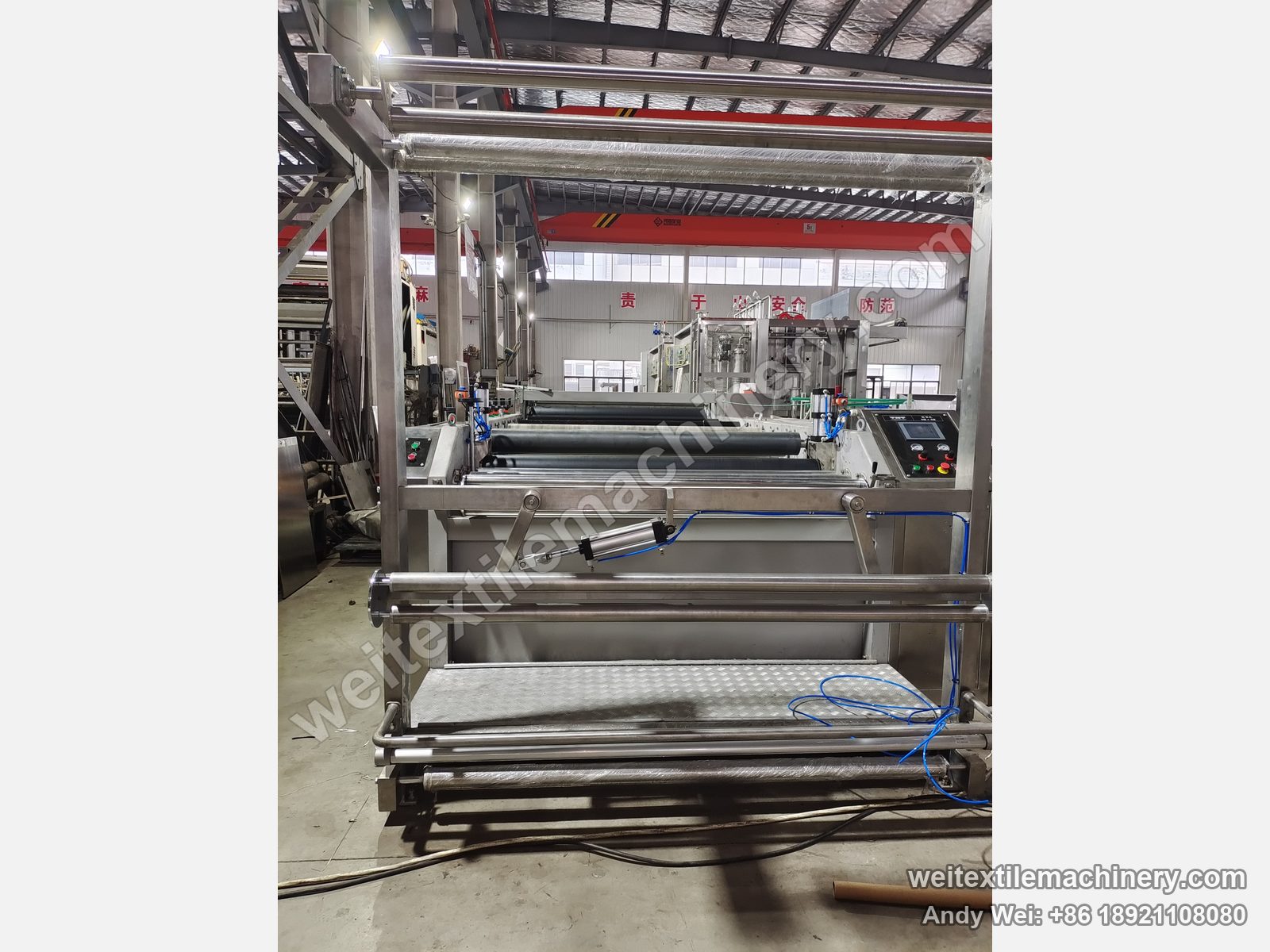 Used TMT STC 4D+4R wet brushing and setting machine, front view with overhead stainless guide rolls, pneumatic swing arm, grating platform and control panel