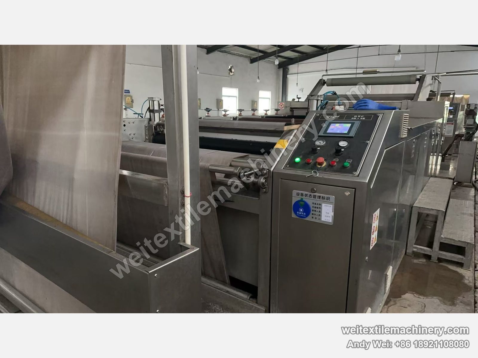 Used TMT STC series wet brushing and setting machine (panel marked 6D+6R) in operation, fabric running in, touch-screen panel and equipment status tag