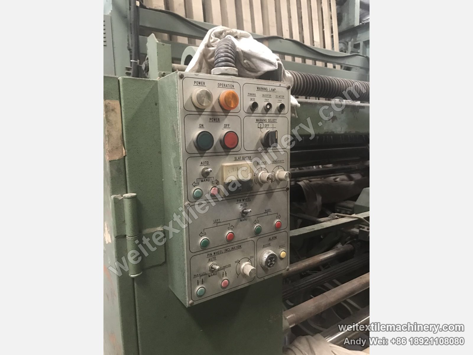 Used Tsuchiya pin-wheel weft straightener, control box with English labels: SLAT GUIDER meter, PIN WHEEL auto/manual and inclination knobs, alarm buzzer