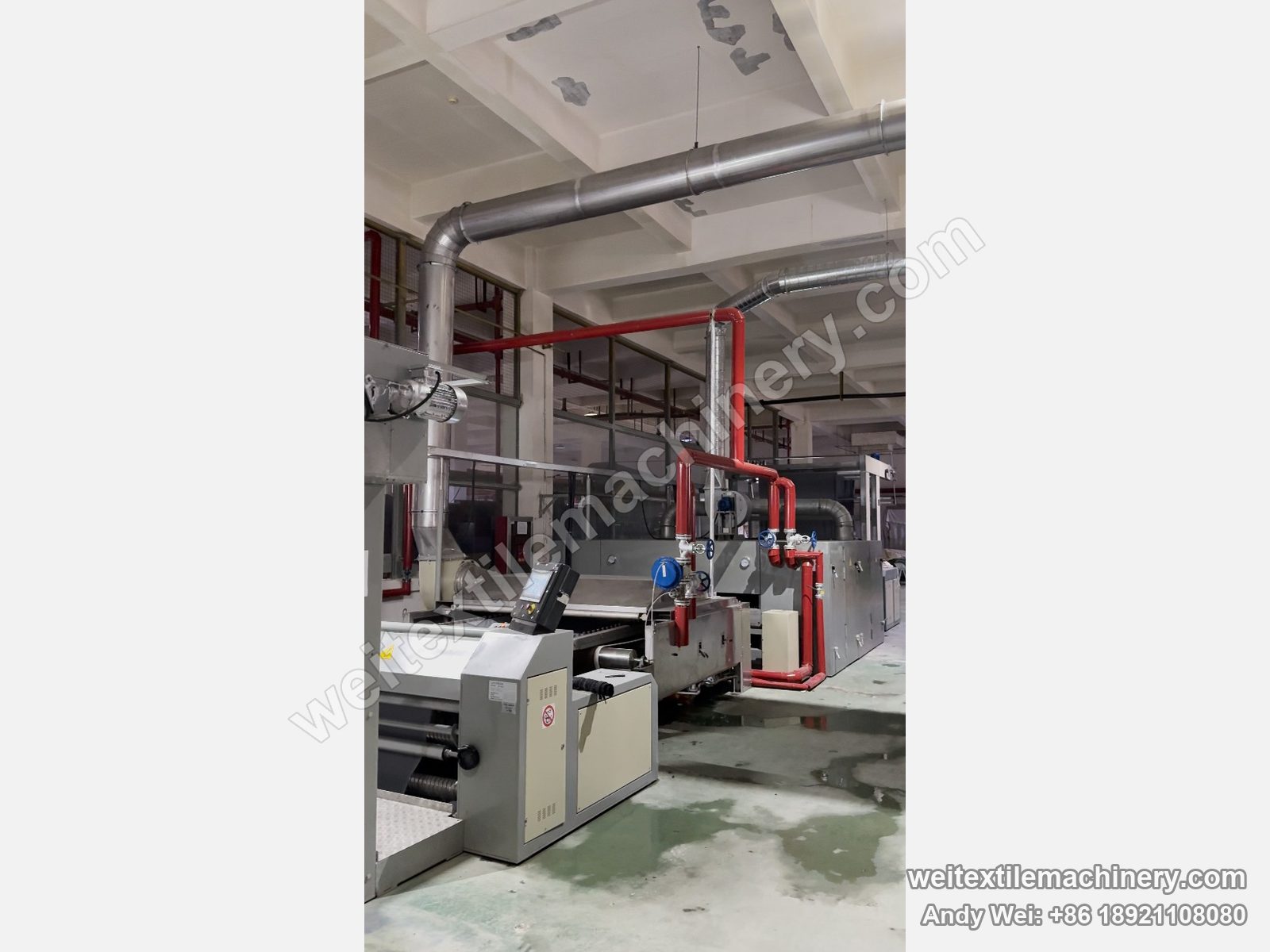 Used Unitech F2 pin-chain steaming-shrinking machine, full line with grey body, red steam piping, top exhaust ducts and front operator panel