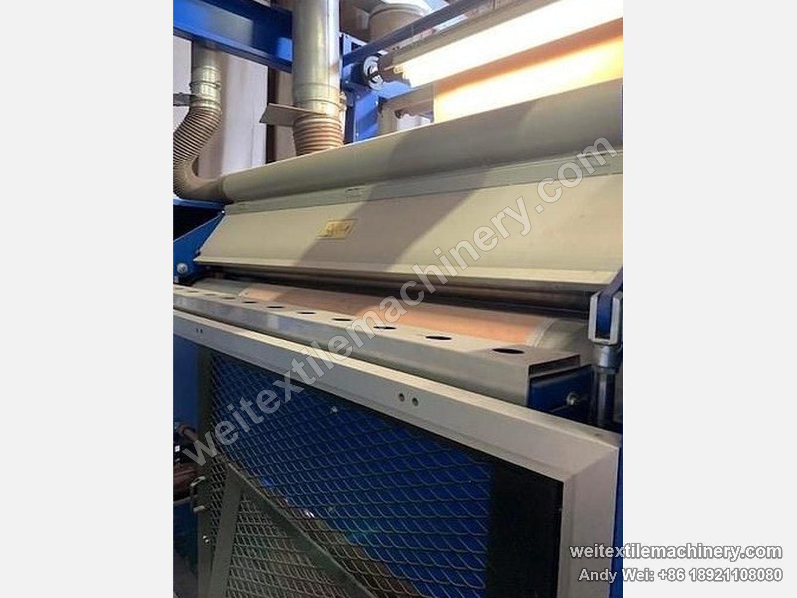 Used Unitech shearing machine (2.2 m), shearing head area with ledger blade bed, suction hood and blue mesh guard below