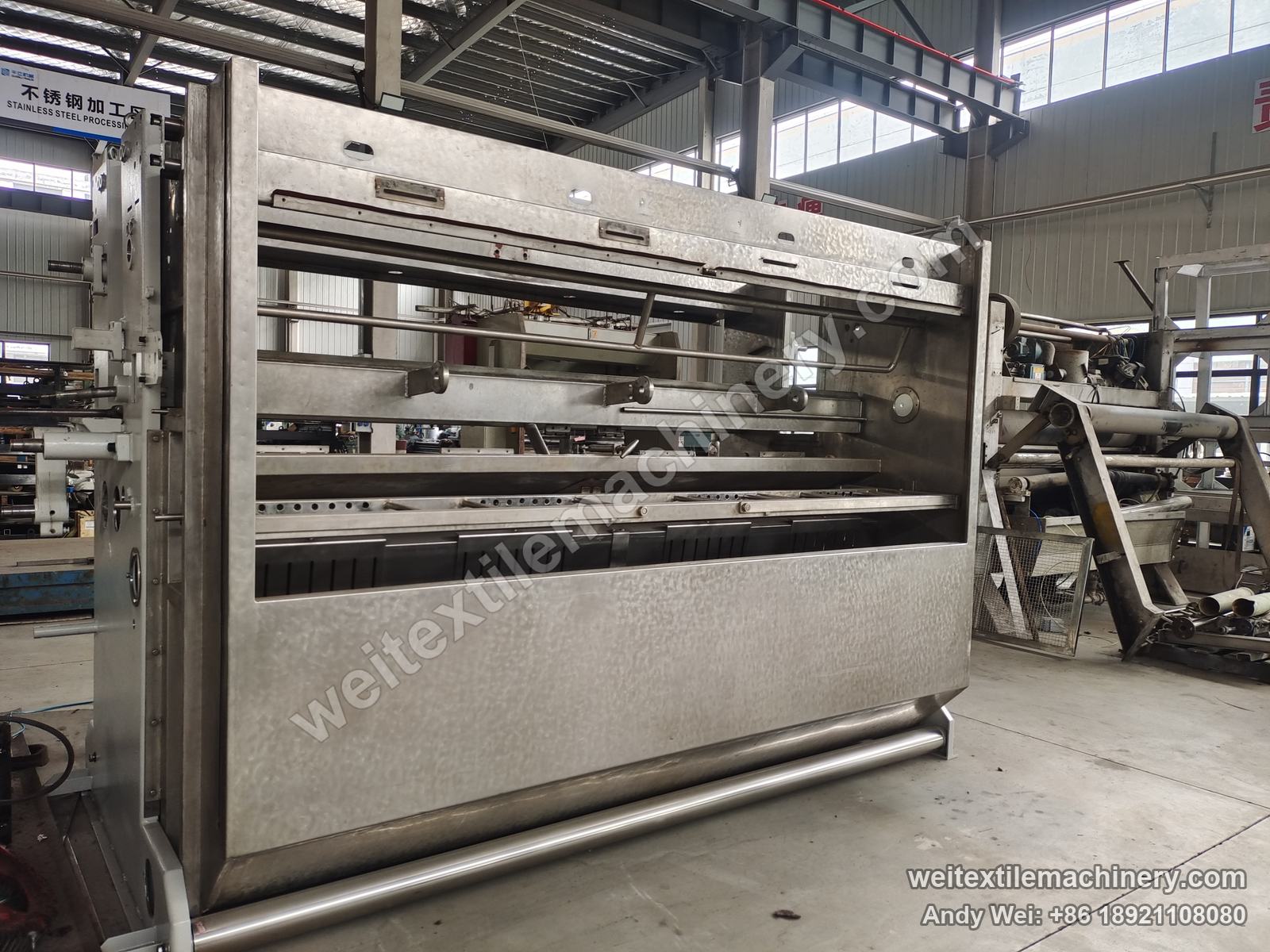 Used Zonco Flexicom 800 rope scouring and milling machine, stainless body with doors removed showing rolls and tank, QL stainless-steel area behind
