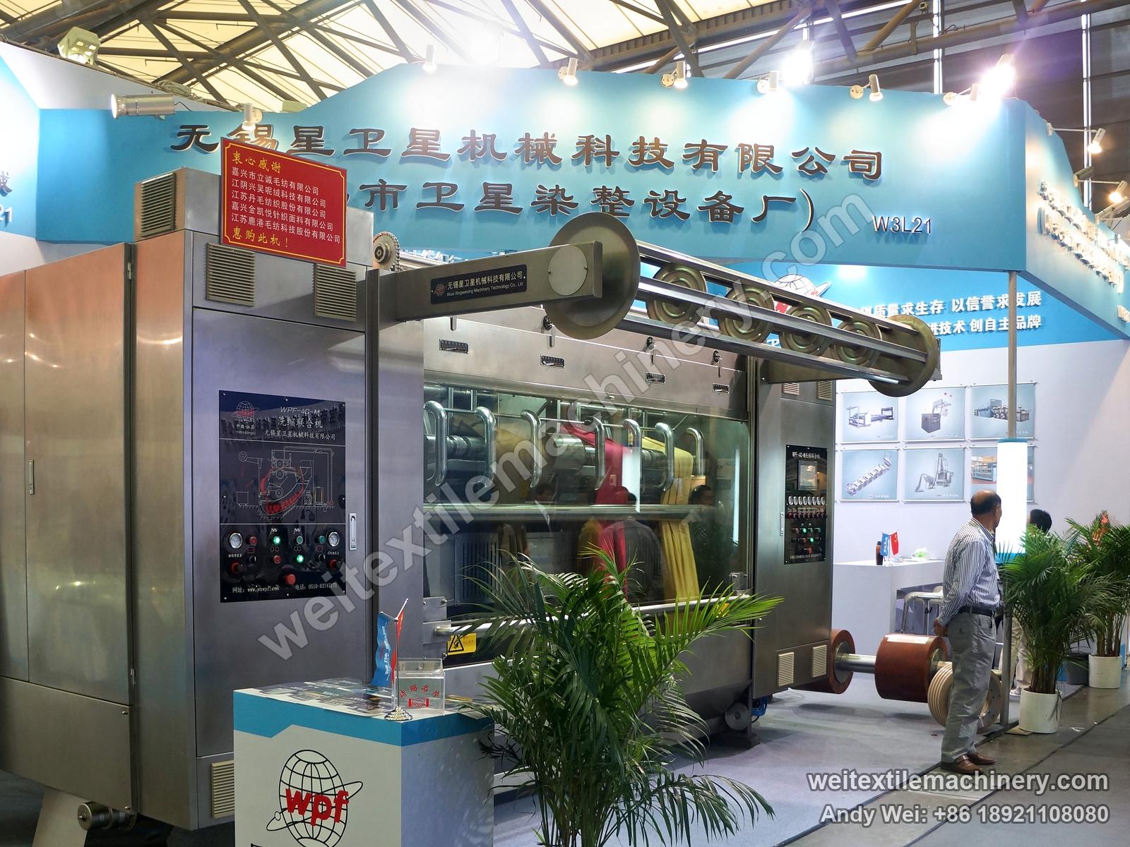 The WPF-4C-M scouring and milling machine on the 2013 stand, with wooden milling rollers beside it