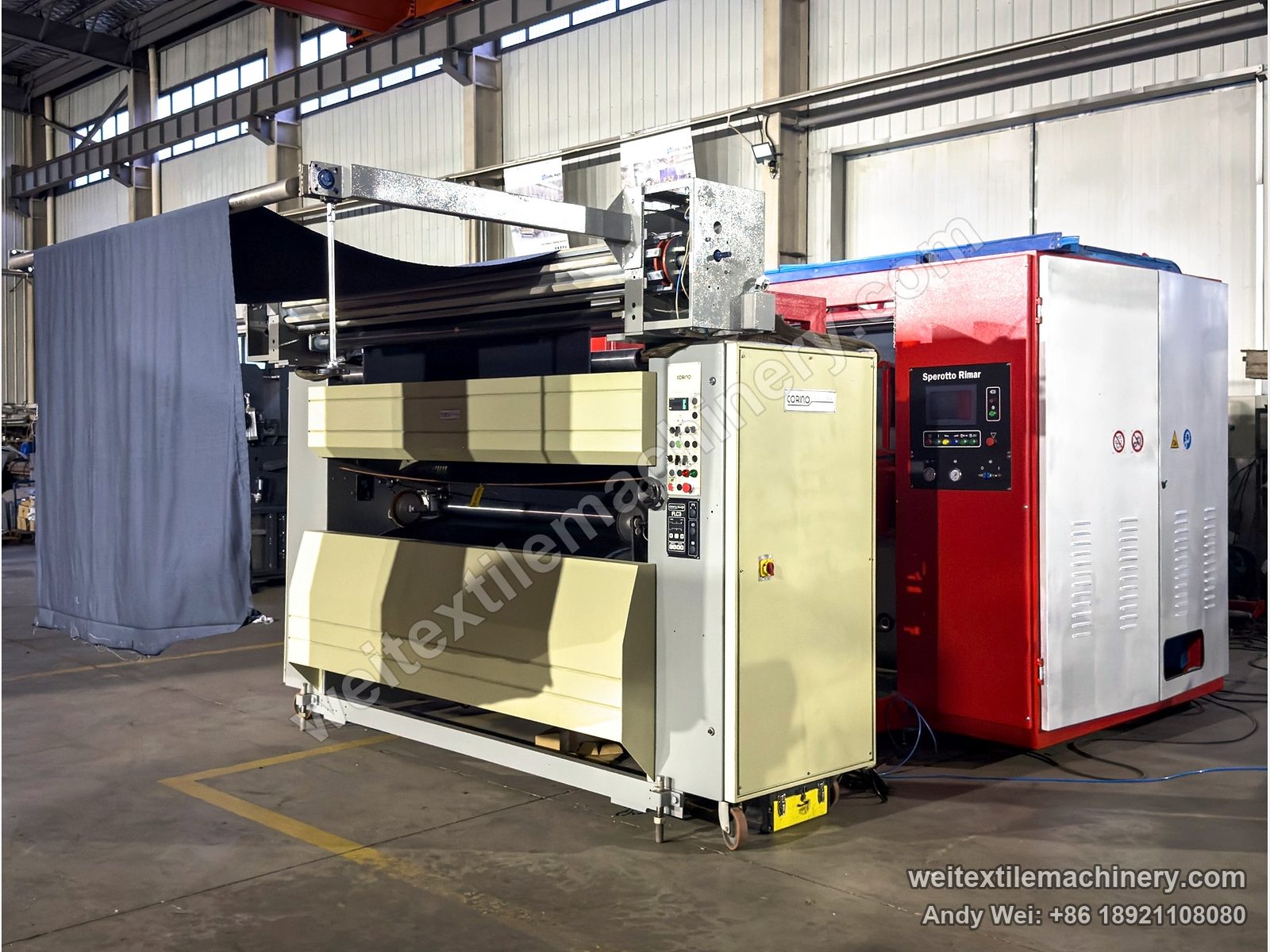 Two rebuilt European machines in the QL workshop: a beige machine with a Corino Macchine nameplate in front, a red machine with Sperotto Rimar on its control panel behind, and grey fabric hanging on the left